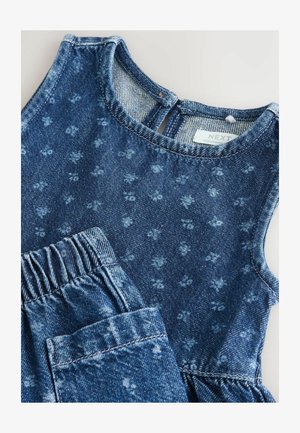 Tumesinise lillemustriga teksariietus, millel on varrukateta särk ja elastse vööümbrisega püksid. Pehme tekstuur ja vabaaja disain.