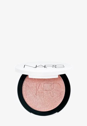 NARS highlighter compact with a shiny rose-gold embossed powder. Round white case with black accents and NARS logo on the lid.