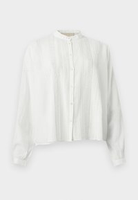 Λευκό πουκάμισο με μακριά μανίκια, με πιέτες και δαντελένιες εμπρός λωρίδες, κούμπωμα με κουμπιά και κοντό όρθιο γιακά.