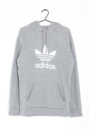 Hellgrauer Adidas Hoodie mit vorderer Kängurutasche, Kapuze mit Kordelzug und großem weißem Trefoil-Logo mittig auf der Brust, hängend an einem schwarzen Kleiderbügel.