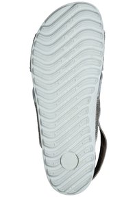 White rubber sole with textured pattern and grooves. Upper material is light gray fabric with a brown accent. Simple, flat design.