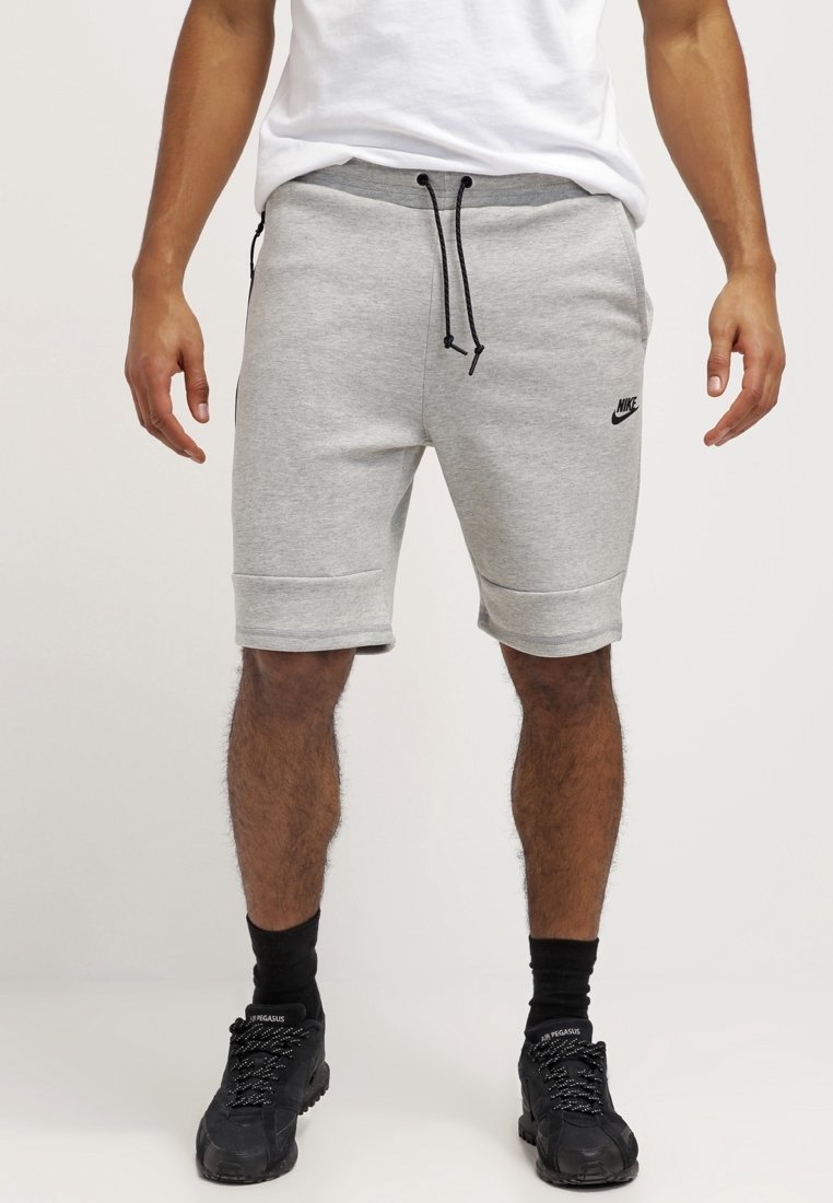 Gray cotton sweat shorts with an elastic waistband, drawstring, and side pockets; features a black Nike logo on the left thigh.