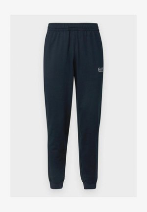 Pantalones deportivos azul marino ajustados con cinturilla elástica, puños en los tobillos y pequeño logo blanco EA7 Emporio Armani en el muslo derecho.