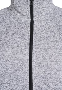 Gray zippered jacket made of a textured knit fabric with a high collar and contrasting black zipper.