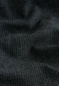 Dark gray fabric with fine vertical pinstripes and soft, slightly wrinkled texture.