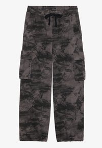 Loose-fit cargo pants with black and gray abstract camouflage pattern, elastic waistband with black drawstring, and side flap pockets.