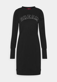 Vestido negro de manga larga con escote redondo, mangas abullonadas y bordado en blanco que dice "DREAM" en el frente. Tejido suave y cómodo.