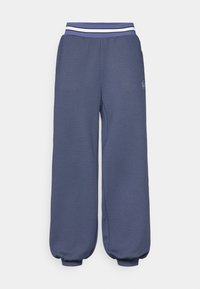 Mørkeblå joggebukser med elastisk midje og hvite striper. Løs passform med tapered mansjetter ved anklene og teksturert stoff.