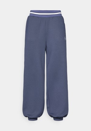 Marineblauwe sweatpants met elastische tailleband en witte strepen. Loose fit met taps toelopende boorden bij de enkels en een textuur stof.