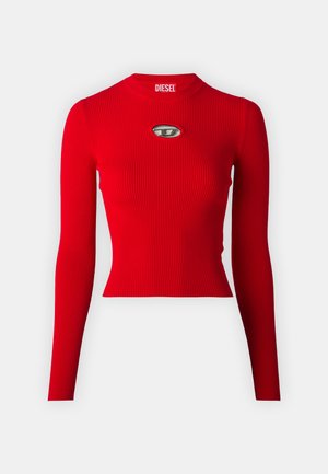 Red ribbed long-sleeve top with a fitted design and a rounded neckline. Features a metallic logo accent on the chest. Smooth texture.