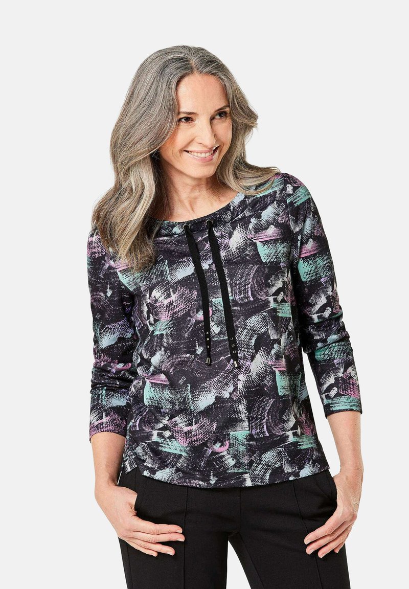 Schwarzer und mehrfarbig gemusterter Sweatshirt mit langen Ärmeln, rundem Ausschnitt und Kordelzug-Details. Hergestellt aus weichem, strukturiertem Material.