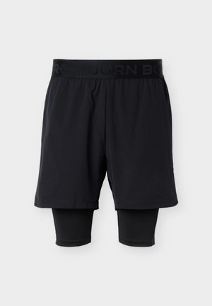 Pantaloncini atletici neri con leggings compressivi aderenti attaccati che si estendono oltre il ginocchio, vita elasticizzata con marchio sottile.