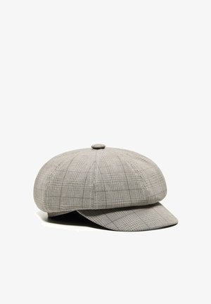 Graue, kariertes Schiebermütze mit rundem Knopf oben und kurzem vorderen Schirm, vor weißem Hintergrund präsentiert.