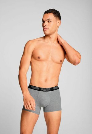 Gray boxer briefs made of a soft, stretchy fabric with a black waistband featuring the Puma logo. The design is fitted with a smooth texture.