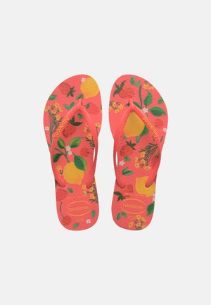 Bright coral flip-flops with green leaves, yellow lemons, and small flowers pattern, featuring textured straps and brand logo on footbed and straps.