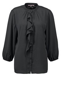Blouse noire à manches longues avec détail froufrou à l'avant, fermeture par boutons et poignets froncés, col rond.