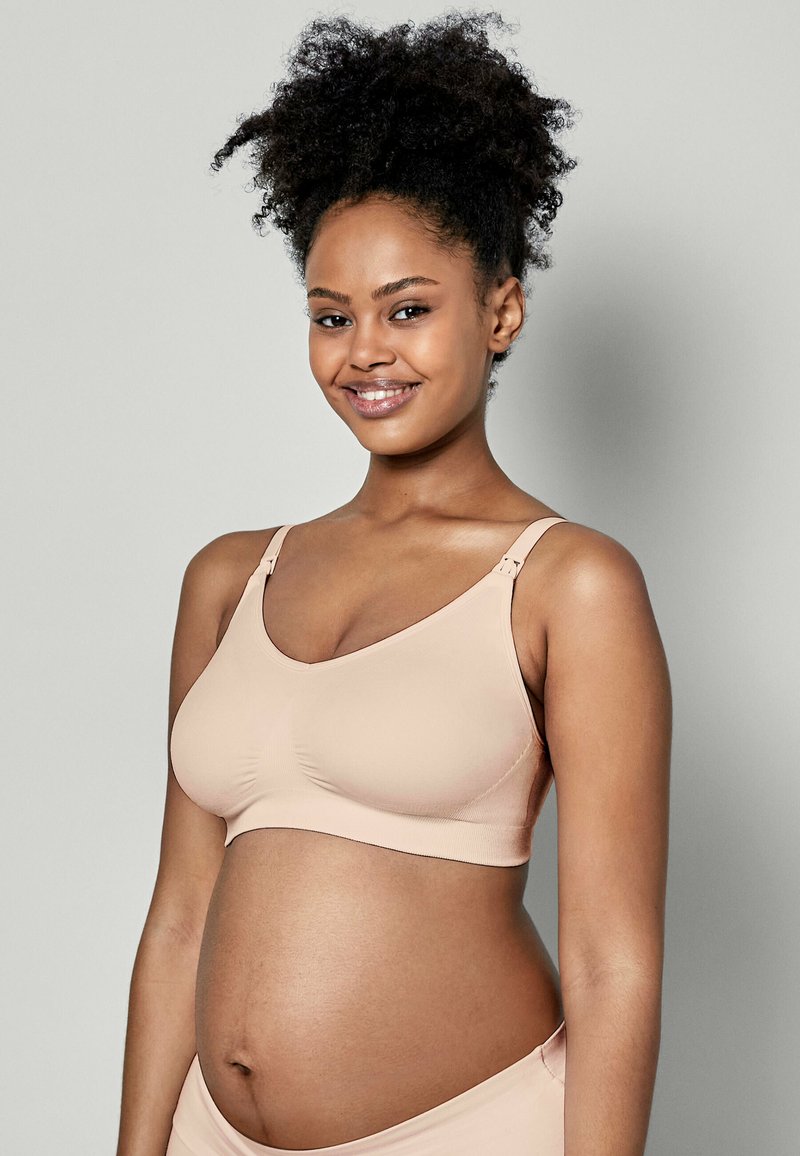 Beige Still-BH aus glattem, elastischem Stoff. Mit breiten Trägern und einem runden Ausschnitt, entworfen für Komfort und Unterstützung.