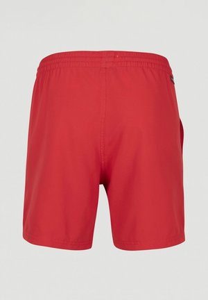 Red swim shorts with an elastic waistband, smooth texture, and a logo accent near the back. Short length and straightforward design.