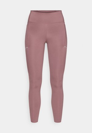 Leggings aderenti a vita alta di colore rosa tenue. Realizzati in tessuto liscio ed elastico con tasca laterale e dettagli di cuciture minime.