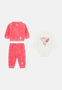Felpa rosa in pile con zip e motivo orsetto, abbinata a pantaloni coordinati, il tutto indossato con un body bianco a maniche lunghe con una grafica.