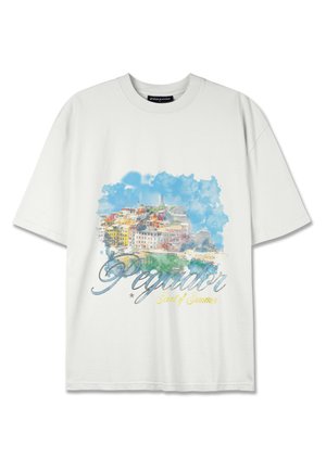 White cotton T-shirt featuring a watercolor-style print of a colorful coastal town with the text "Pegador Scent of Summer" in blue and yellow.