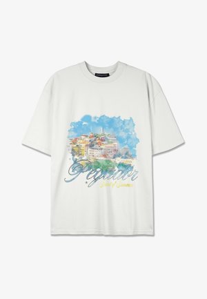 White cotton T-shirt featuring a watercolor-style print of a colorful coastal town with the text "Pegador Scent of Summer" in blue and yellow.