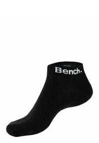 Black ankle sock with ribbed texture, featuring white "Bench." logo at the cuff. Soft material, low-cut design, rounded toe.