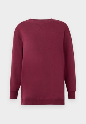 Maroon sweatshirt with long sleeves, crew neck, and ribbed cuffs. Smooth texture with a slight sheen, featuring a cross-stitch detail on the back.