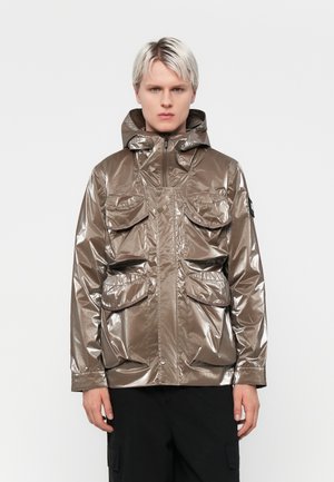 Metallic brown waterproof jacket with a hood, zip front, and four front pockets. Features a textured, reflective surface.