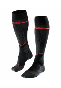 Calcetines negros hasta la rodilla con acentos rojos, que cuentan con un diseño texturizado y refuerzo en el talón y la punta para mayor durabilidad y comodidad.