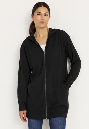 Black zip-up hoodie made of textured ribbed fabric, with a hood and two front pockets. Features long sleeves and a relaxed fit.