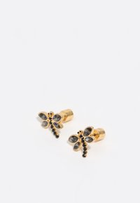 Pendientes de botón en tono dorado en forma de libélula, con gemas grises y acentos de cuentas negras, en un diseño estructurado.