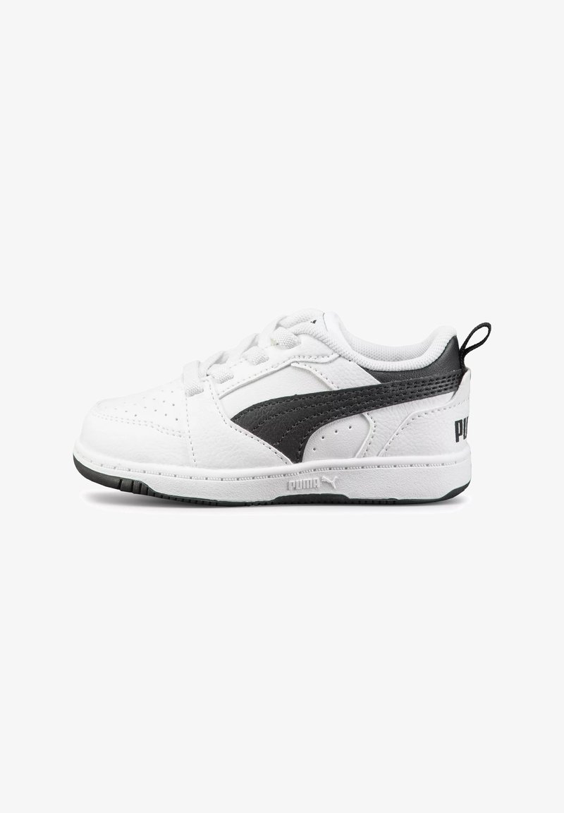 White sneakers with black accents, featuring a textured leather upper, perforated toe detailing, and a rubber sole. PUMA branding visible.