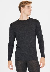 Zwart thermo shirt met lange mouwen, gemaakt van zachte, gestructureerde stof en met een ronde hals. Het heeft een slim fit en een minimalistisch ontwerp.