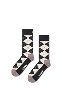 Chaussettes à motif argyle noir et crème avec un accent textuel "HAPPY" en blanc sur un fond noir, présentant un bout et un talon beiges unis.