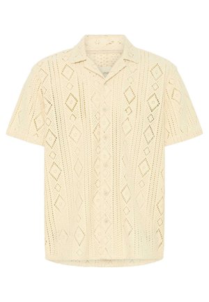 Κοντομάνικο κρεμ πουκάμισο με πλεκτό μοτίβο δαντέλας σε σχήμα ρόμβου και γιακά με κουμπιά μπροστά.