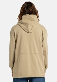 Beige hoodie with a large hood, relaxed fit, and a smooth texture. Features a horizontal seam across the back and ribbed cuffs.