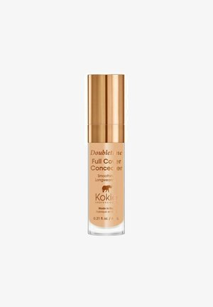 Täyden peittävyyden peiteainepullo kultaisella korkilla, merkintä "Doubletone" Kokien valmistama, tasoittava, pitkäkestoinen, 6 ml (0,21 fl oz), valmistettu Italiassa.