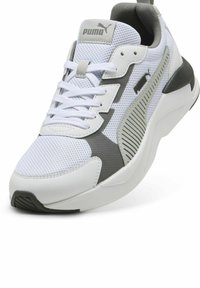 White athletic shoe with a breathable mesh upper, grey accents, rubber sole, and prominent logo detail on the tongue.