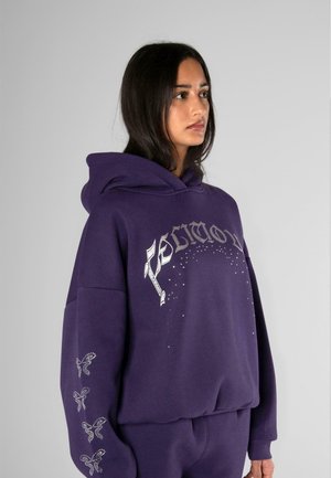 Purple hoodie made of soft fabric featuring metallic silver lettering and decorative accents on sleeves. Stylish and loose fit design.