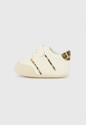 Cream toddler sneakers with leopard print accents, a rounded toe, and elastic strap featuring stripes in soft peach and black.