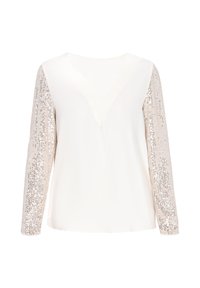 Blusa crema con scollo a V, dotata di maniche lunghe decorate con paillettes argento. La texture liscia sul corpo contrasta con le maniche lucide.