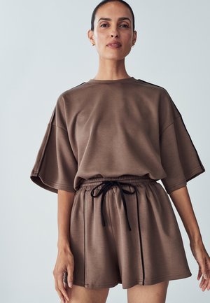 Brown matching short-sleeve top and shorts set. Top features a loose fit, shorts have an elastic waistband with a black drawstring detail.