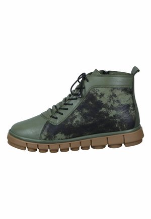 Green leather high-top sneakers featuring a textured black accent, round toe, lace-up front, and chunky brown sole with circular pods.