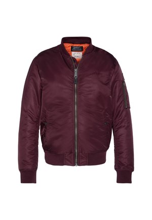 Veste bomber marron avec fermeture éclair à l'avant, poignets et bas côtelés, poche zippée sur la manche gauche et doublure orange à l'intérieur du col.