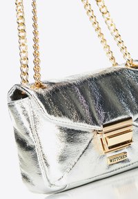 Silver metallic handbag with a textured finish, featuring a gold chain strap and a rectangular clasp with brand detailing.