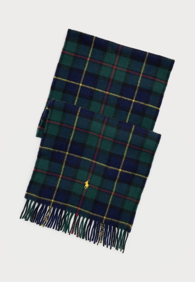 Écharpe en plaid en laine de couleur vert foncé, bleu marine et rouge avec des accents jaunes. Présente des bords frangés et un petit logo doré.