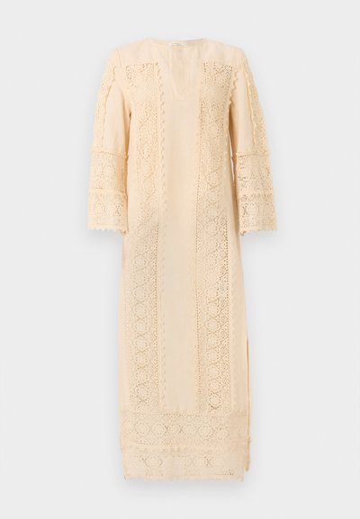 Light beige dress featuring intricate lace detailing along the sleeves and sides, with a relaxed fit and a subtle V-neckline.