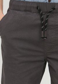 Charcoalgrå shorts lavet af bomuldsblanding, med elastisk talje og sort snor samt sidelommer. Glat tekstur, afslappet design.