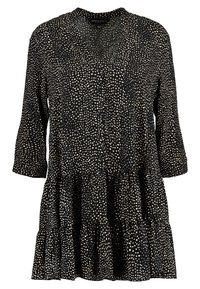 Czarna sukienka w kremowe kropki, zapinana z przodu, z dekoltem w kształcie litery V i rękawami o długości 3/4. Posiada warstwowe, falbaniaste wykończenie u dołu.
